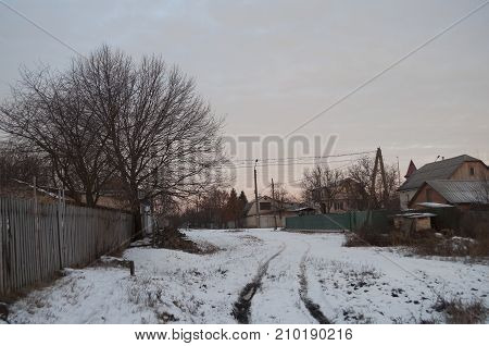 Beautiful morning and winter bright sunrise in January. Suburb and field covered snow