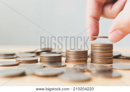 Saving money and investing is growing growth wealthy and sustainable for the future concept Hand of male or female putting coin stack step growing growth financial