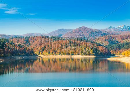 Panoramic view of Lokvarsko lake with Risnjak mountain in background, beautiful colorful mountain autumn landscape, Lokve, Gorski kotar, Croatia