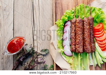 Fast food. Eastern food. Shish kebab, lyulya-kebab, shaverma, pita gyros. Dishes of oriental cuisine lying on pita bread and decorated with greens and vegetables, sauces and French fries.