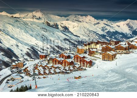 Amazing winter landscape and ski resort with typical alpine wooden houses in French Alps Les Menuires 3 Vallees France Europe