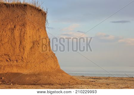 Beach with rocks and a cloudy sky.