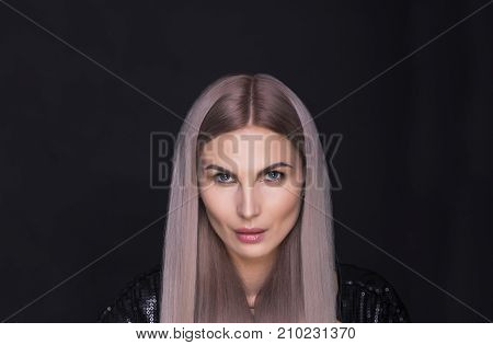 Beautiful lady with long straight trendy blonde hairs studio shot.