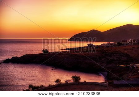 Sunrise. Colorful sky and silhouette at village panormos Crete island - Greece