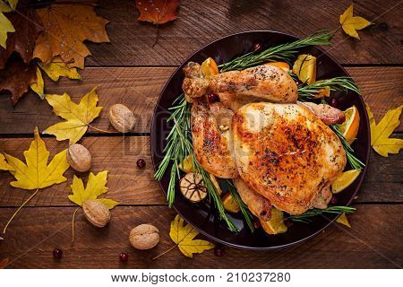 Roasted Turkey Garnished With Cranberries On A Rustic Style Table Decorated With Pumpkins, Orange, A
