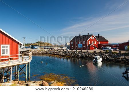 Henningsvaer Norway - August 19 2017: Picturesque fishing port in Henningsvaer on Lofoten islands Norway with typical red wooden buildings and small fishing boats