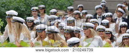 STOCKHOLM SWEDEN - JUN 13 2017: Closeup of group of smiling students wearing white graduation caps after graduation at the dance school Balettakademien June 13 2017StockholmSweden