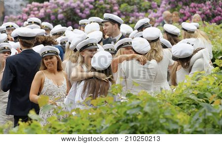 Stockholm Sweden - Jun 13 2017: Happy Teenagers Wearing Graduation Caps Hugging Each Other After Gra