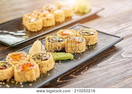 Traditional japanese food on plate. Japanese food roll with fish and avocado. Sushi menu in restaurant.