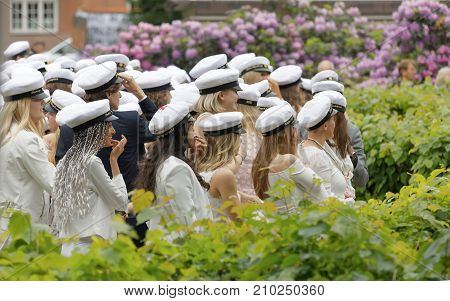 STOCKHOLM SWEDEN - JUN 13 2017: Teenagers wearing white graduation caps after graduation at the dance school BalettakademienJune 13 2017StockholmSweden