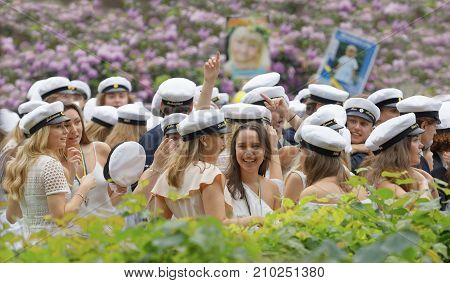 STOCKHOLM SWEDEN - JUN 13 2017: Happy swedish graduating students in a beautiful park with lilac flowers in the background at the dance school Balettakademien June 13 2017StockholmSweden