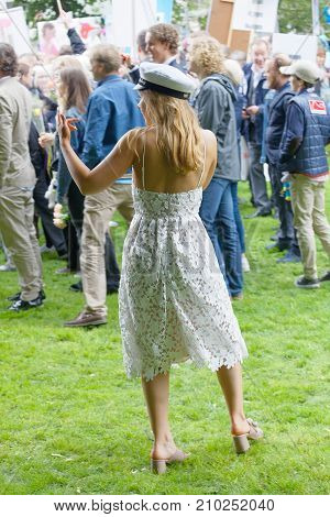 STOCKHOLM SWEDEN - JUN 13 2017: Blonde graduating student girl wearing white graduation cap and white dress rear view at the dance school Balettakademien June 13 2017StockholmSweden