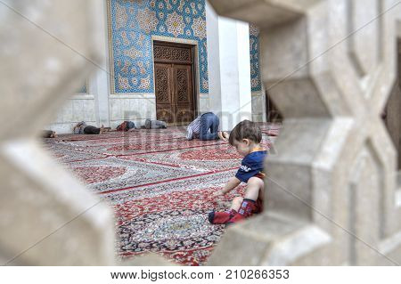 Fars Province Shiraz Iran - 19 april 2017: Shah Cheragh Shrine Muslim men pray and sleep at entrance to mosque Iran.