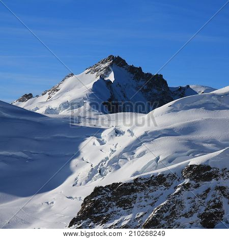 Mount Gletscherhorn and glacier with crevasses. Swiss Alps.