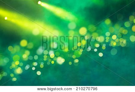 Stage light projector and yellow glitter lights on green background. Abstract Spotlight Glitter lights background.
