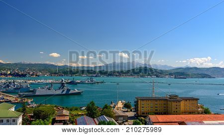 LA SPEZIA ITALY - APRIL 29 2017 - View of the port of La Spezia with boats and mountains at the horizon.