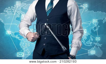 Businessman holding tool with global map graphic on the background
