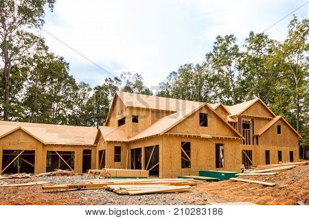 House under construction on a empty lot.