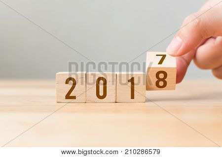 New year 2017 change to 2018 concept Hand flip wood cube