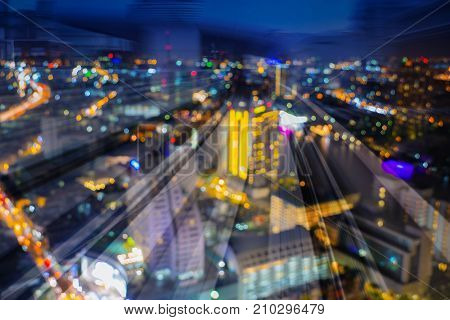 Twilight blurred bokeh light city night double exposure motion train track abstract background
