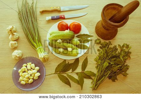Fresh organic vegetables on table. Include fresh organic vegetables and Cucumber on wooden floor. Green Cucumber garlic. Summer frame with fresh organic vegetables on wooden background - Retro color