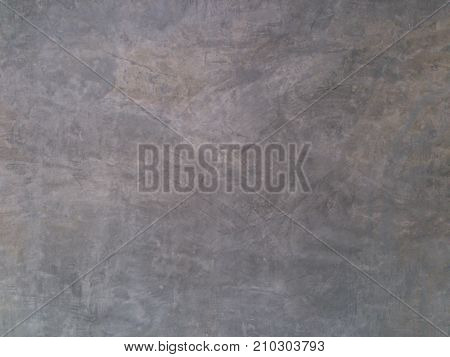 The wall is polished and beautiful in front of the wall in the background.