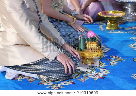 Groom and bride with tray of gift in traditional Thai wedding ceremony. Concept of marriage.