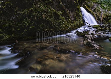 waterfall on a mountain river through the Yellow Keys. Romania