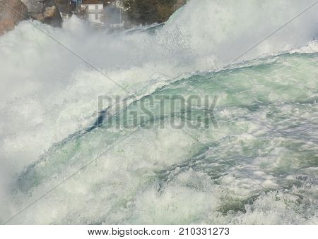 Partial view of the Rhine Falls waterfall in Switzerland seen from the Laufen castle. The Rhine Falls is the largest waterfall in Europe located on the border between the Swiss cantons of Zurich and Schaffhausen.
