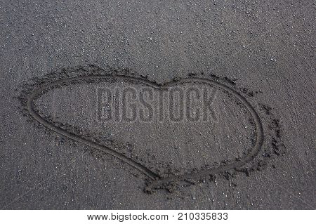 drawing of a heart on the sand on a black beach in Iceland