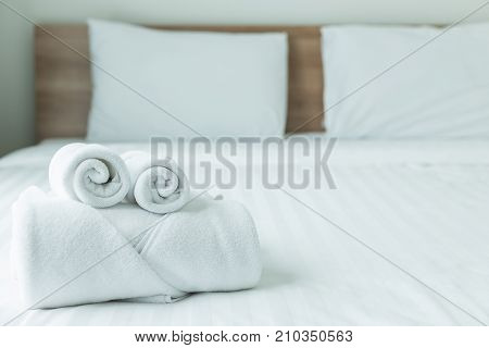 Roll Of White Towel On The Bed Table In Luxury Modern Hotel Room