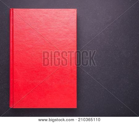 Red Book With Blank Empty Cover On Black Stone Table Background