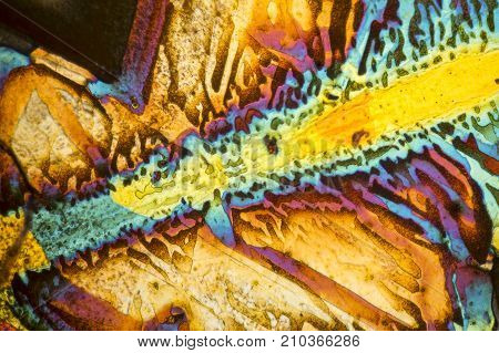 colorful microscopic shot of salt acid microcrystals in polarized light