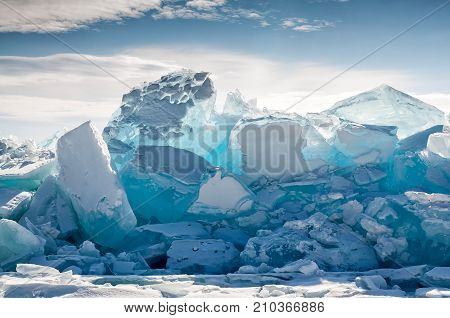 Endless blue ice hummocks in winter on the frozen Lake Baikal. Russia