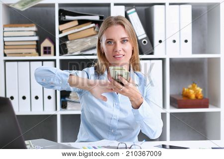 Beautiful businesswoman portrait. Scattering money notes dollars in fashion vows style  curly hair with white locks eye view of the camera