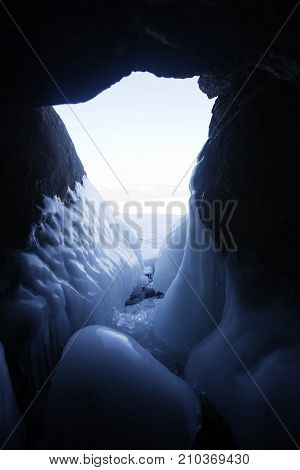 Icicles In Cave. Lake Baikal, Oltrek Island. Winter Landscape