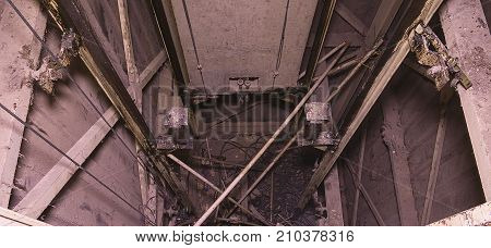 Old elevator shaft with counterweight. Lift reconstruction. Industrial object. Close-up.