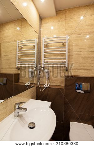 White washbasin with mirror toilet bowl dryer in the combined bathroom.