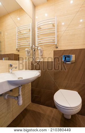 White washbasin with mirror toilet bowl dryer in the combined bathroom.