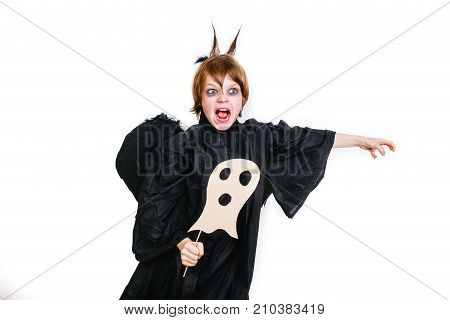 Happy boy in a black angel costume having fun on hallloween party