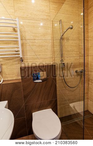 White washbasin with mirror toilet bowl dryer in the combined bathroom.