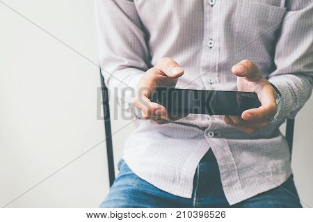 Business process photo. Account manager using mobile phone. Typing contemporary smartphone screen.