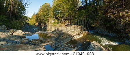 mountain river in the autumn forest, Autumn landscape, fallen leaves, water flow
