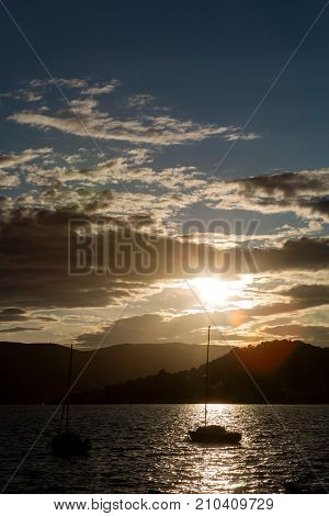 yachts docked at the pier in the Bay of Montenegro at sunset and mountain