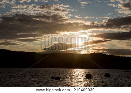 yachts docked at the pier in the Bay of Montenegro at sunset and mountain