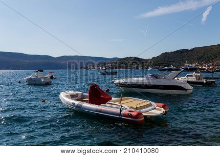 Herceg-Novi, Montenegro - September 26: boats and yachts docked at the pier in the Bay of Montenegro and mountains in the background in the European day of languages on September 26, 2017