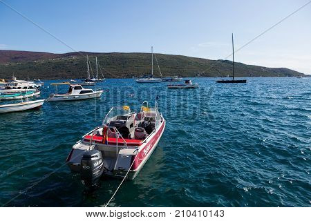 Herceg-Novi, Montenegro - September 26: boats and yachts docked at the pier in the Bay of Montenegro and mountains in the background in the European day of languages on September 26, 2017
