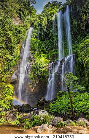 View of the falling water of the Sekumpul waterfall in the Indonesian jungle