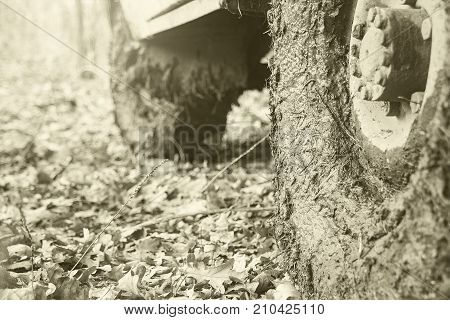 Dirty the wheels of the car after off-road. The car is in the autumn forest, fallen leaves. Selective focus