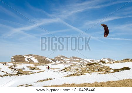 Skier rides with snow kite. Snowkiting. Horizontal view